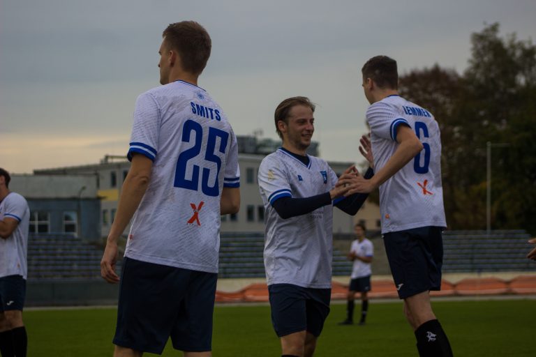 Players of Krakow Dragoons FC greeting each other during a substitution