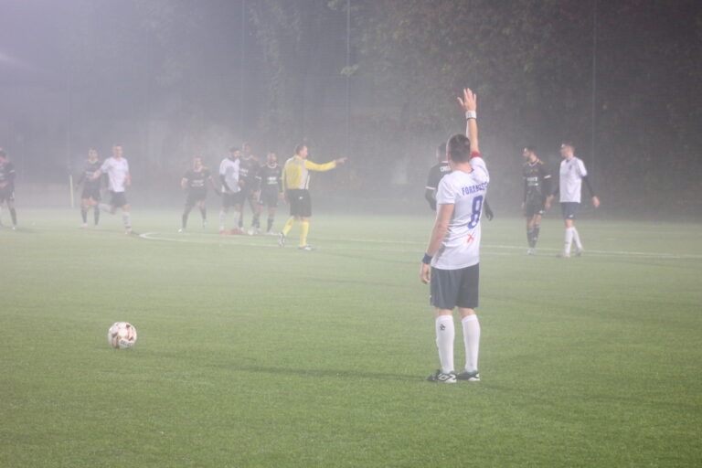 Enrico Forabosco of Krakow Dragoons FC raising his hand in the air while preparing to take a free kick vs Vinsky FC