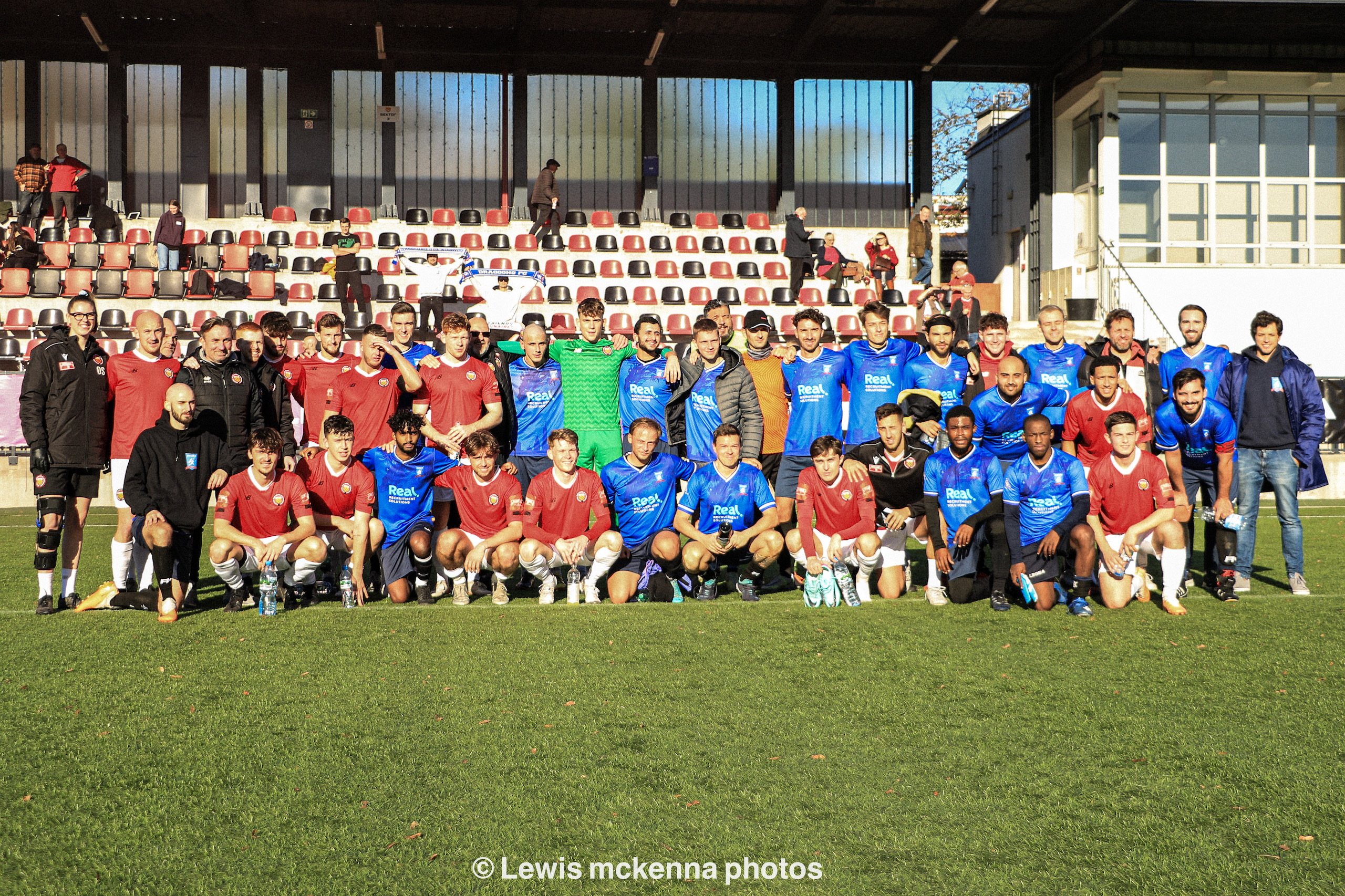 Krakow Dragoons FC and FC United of Manchester players and staff pose together for a post-match photo
